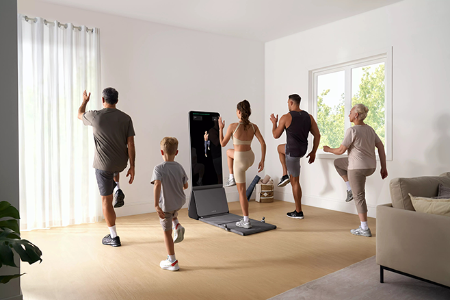 Family doing a home workout together, following a smart mirror fitness class.